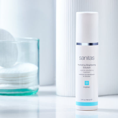 hydrating brightening solution on table with cotton rounds in jar