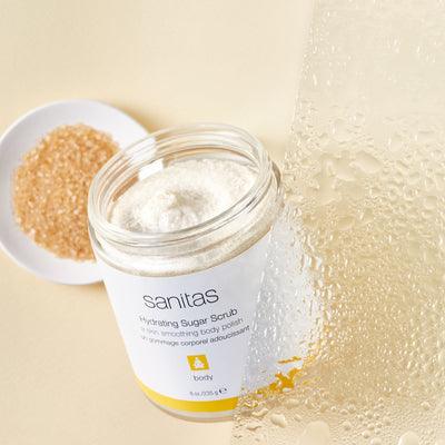 hydrating sugar scrub with cup of brown sugar behind it