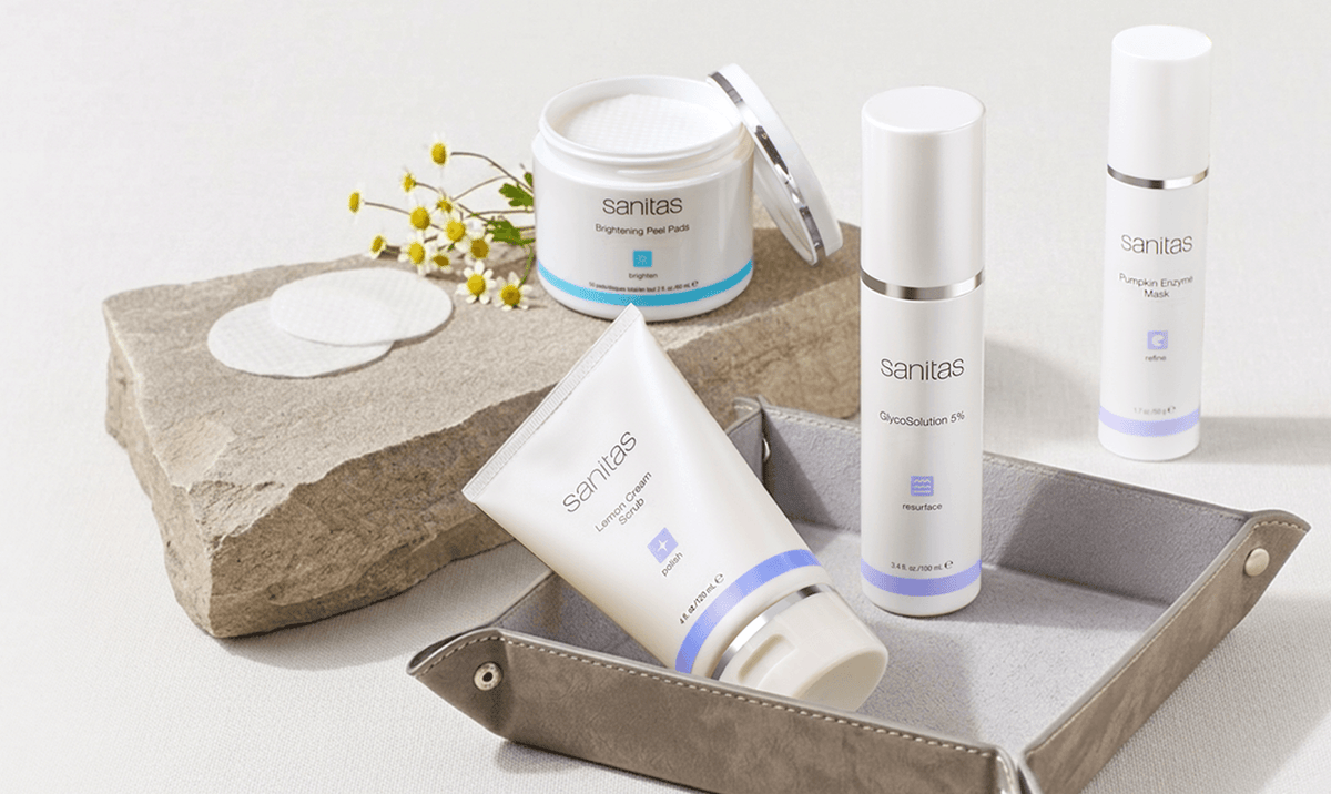 Santas skincare products on a stone and leather tray with flowers.
