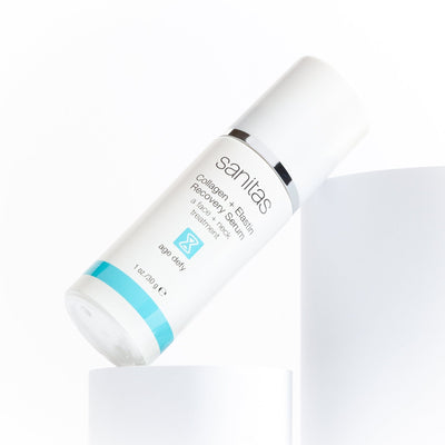 collagen + elastin serum 30 g leaned up against white riser 